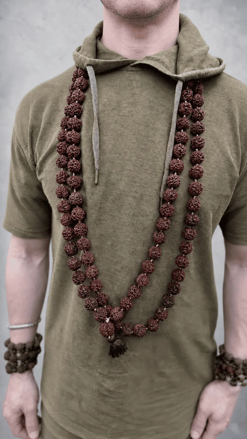 A man wearing a rudraksha mala